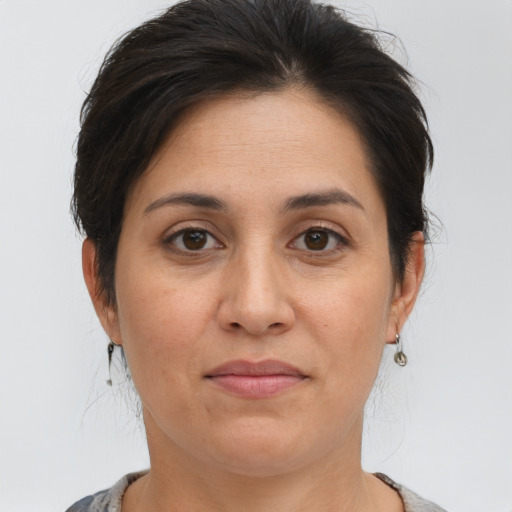 Joyful white adult female with medium  brown hair and brown eyes