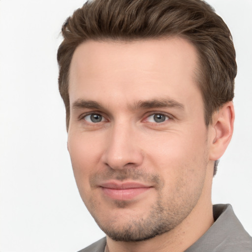 Joyful white young-adult male with short  brown hair and brown eyes