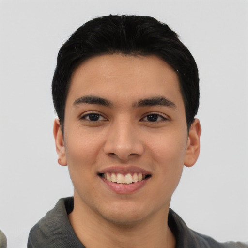 Joyful asian young-adult male with short  black hair and brown eyes