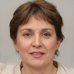 Joyful white adult female with medium  brown hair and brown eyes