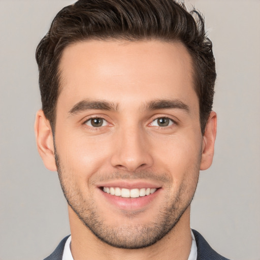 Joyful white young-adult male with short  brown hair and brown eyes