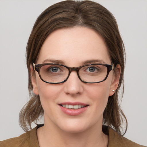 Joyful white young-adult female with medium  brown hair and blue eyes