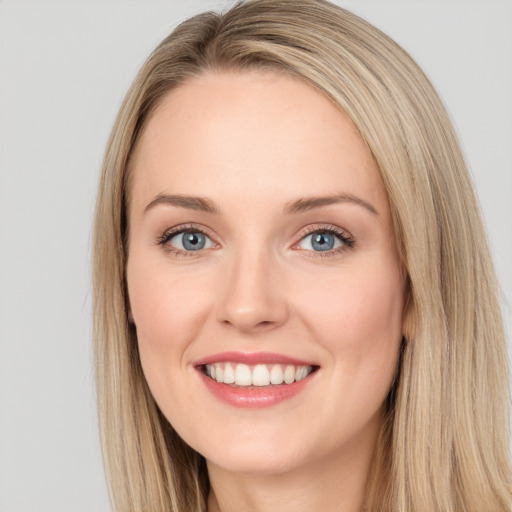 Joyful white young-adult female with long  brown hair and blue eyes