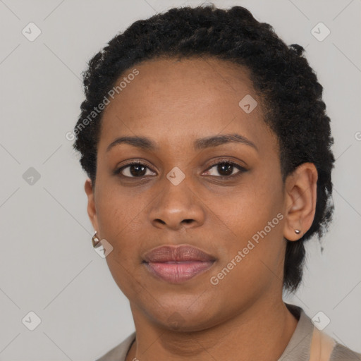 Joyful black young-adult female with short  black hair and brown eyes