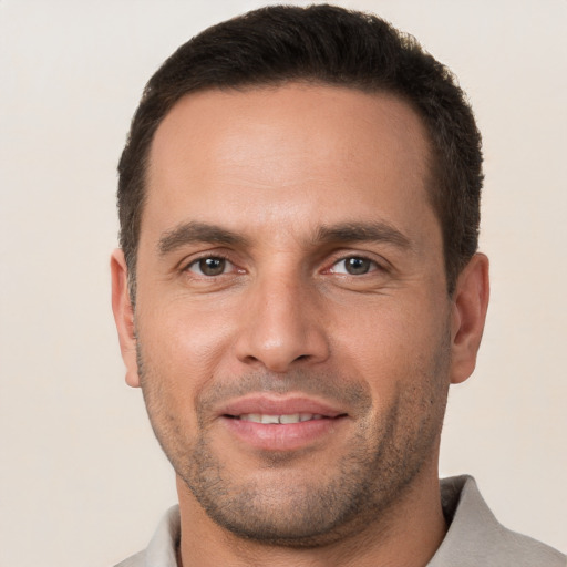 Joyful white young-adult male with short  brown hair and brown eyes