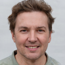 Joyful white adult male with short  brown hair and grey eyes