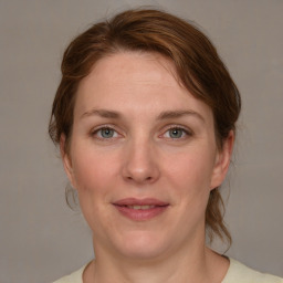 Joyful white adult female with medium  brown hair and grey eyes