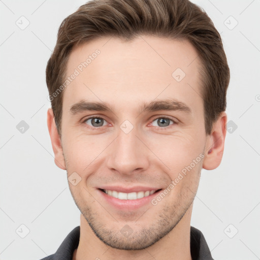 Joyful white young-adult male with short  brown hair and grey eyes