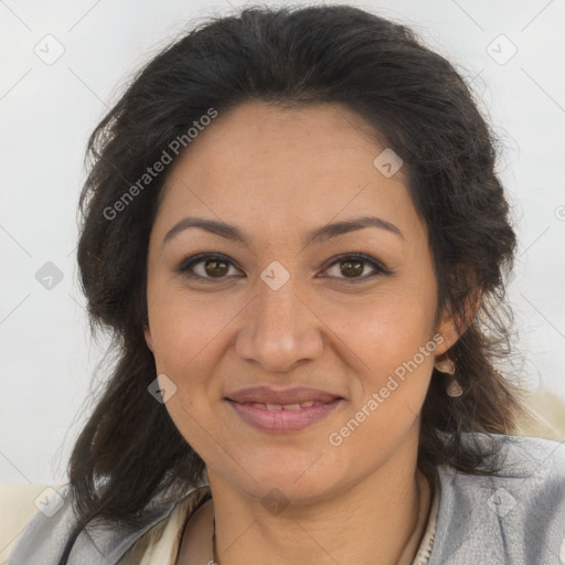 Joyful latino adult female with medium  brown hair and brown eyes