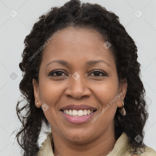 Joyful black young-adult female with long  brown hair and brown eyes