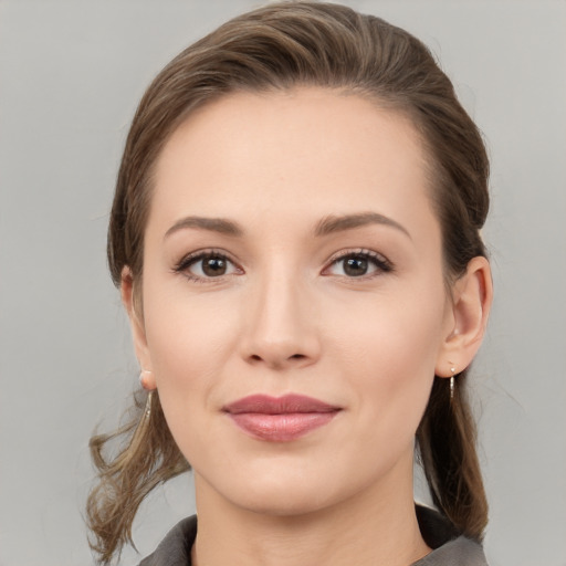 Joyful white young-adult female with medium  brown hair and grey eyes