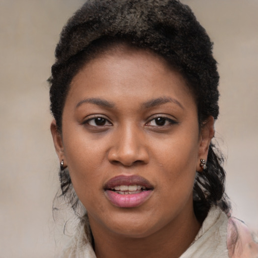Joyful black young-adult female with short  black hair and brown eyes