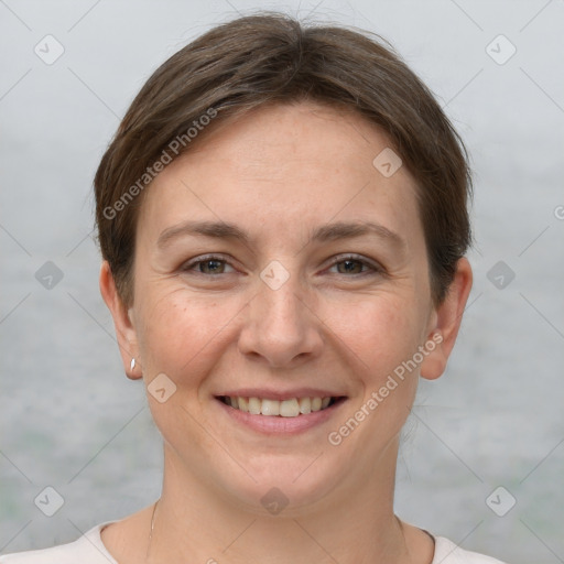 Joyful white adult female with short  brown hair and grey eyes