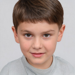 Joyful white child male with short  brown hair and brown eyes