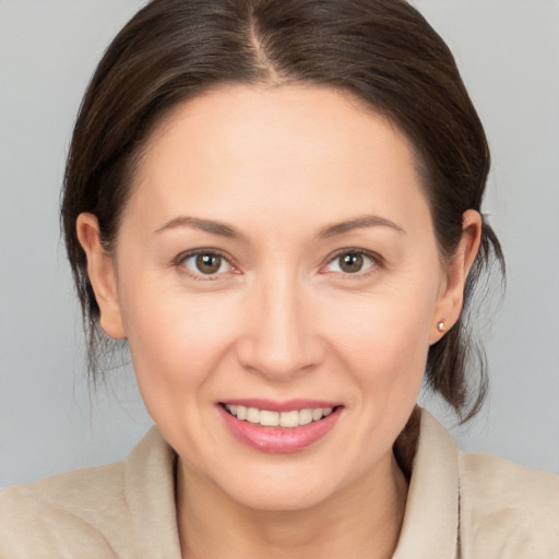 Joyful white adult female with medium  brown hair and brown eyes