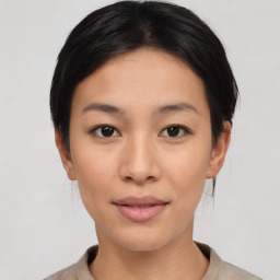 Joyful asian young-adult female with medium  black hair and brown eyes