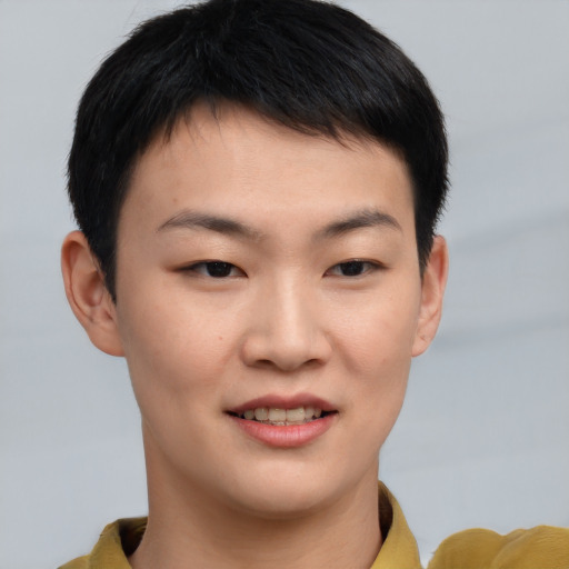 Joyful asian young-adult male with short  brown hair and brown eyes