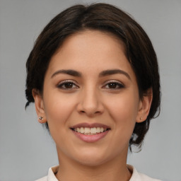 Joyful latino young-adult female with medium  brown hair and brown eyes