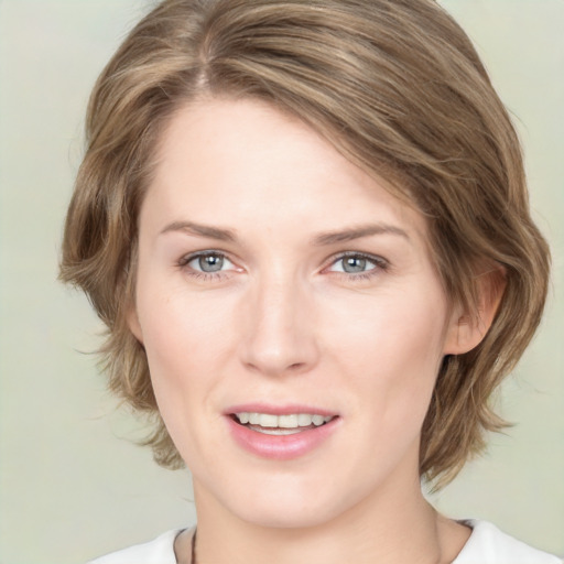 Joyful white young-adult female with medium  brown hair and green eyes