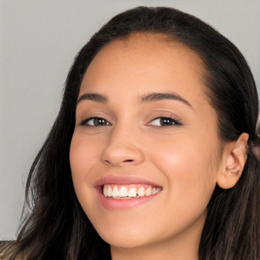 Joyful white young-adult female with long  brown hair and brown eyes