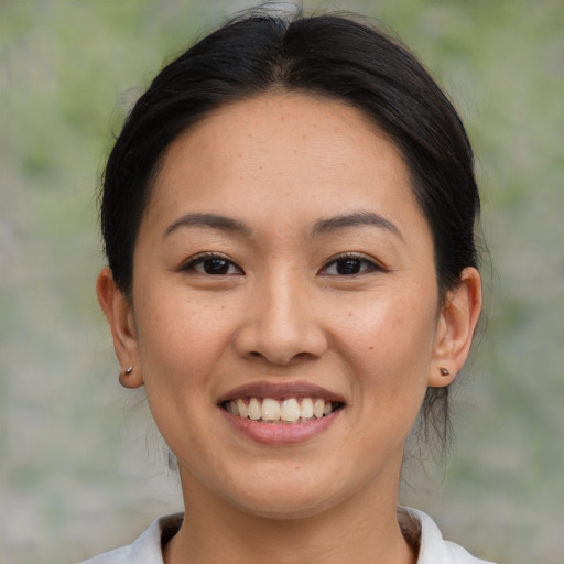 Joyful asian young-adult female with medium  brown hair and brown eyes