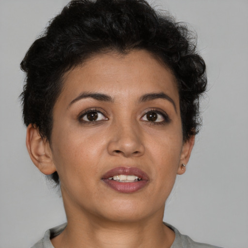 Joyful latino young-adult female with short  brown hair and brown eyes