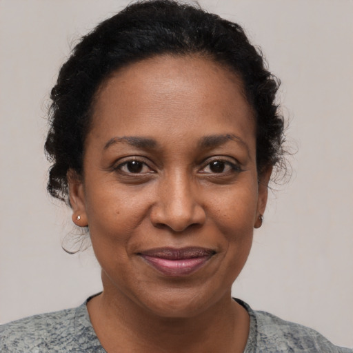 Joyful black adult female with short  brown hair and brown eyes