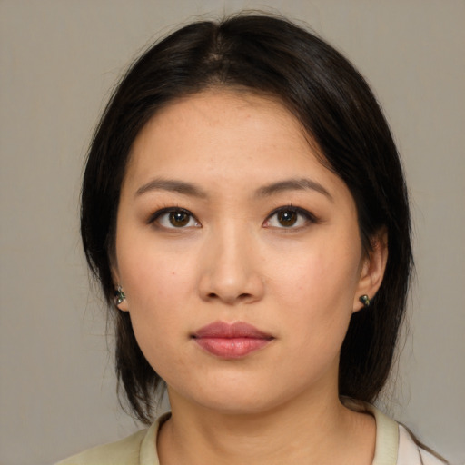 Neutral asian young-adult female with medium  brown hair and brown eyes