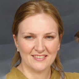 Joyful white adult female with medium  brown hair and blue eyes