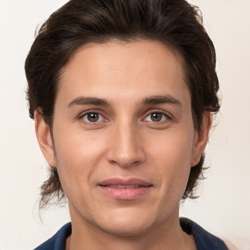 Joyful white young-adult male with medium  brown hair and brown eyes