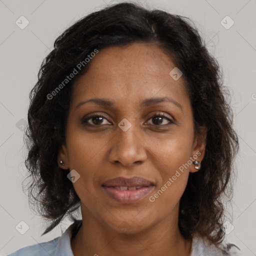 Joyful black adult female with medium  brown hair and brown eyes