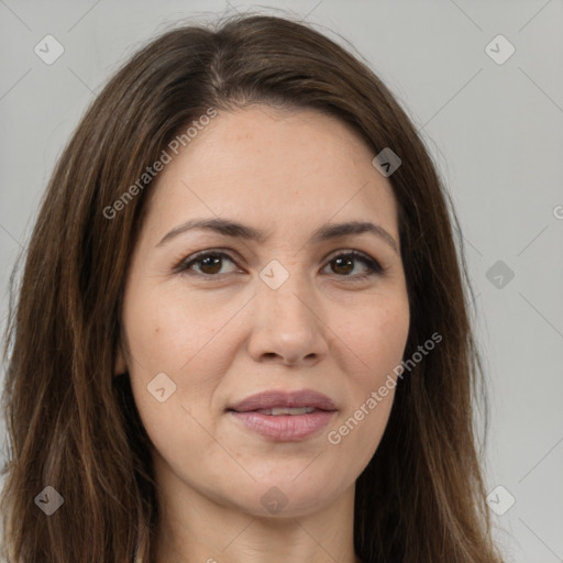 Joyful white adult female with long  brown hair and brown eyes