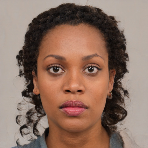 Neutral black young-adult female with medium  brown hair and brown eyes
