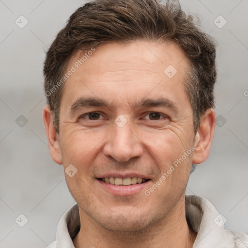 Joyful white adult male with short  brown hair and brown eyes