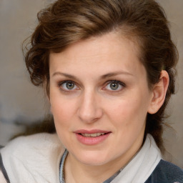 Joyful white young-adult female with medium  brown hair and blue eyes