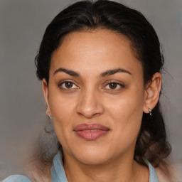 Joyful latino adult female with medium  brown hair and brown eyes