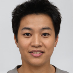 Joyful asian young-adult male with short  black hair and brown eyes