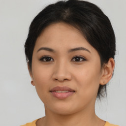 Joyful latino young-adult female with medium  brown hair and brown eyes