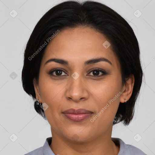 Joyful latino adult female with medium  brown hair and brown eyes