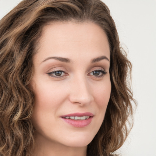 Joyful white young-adult female with long  brown hair and green eyes