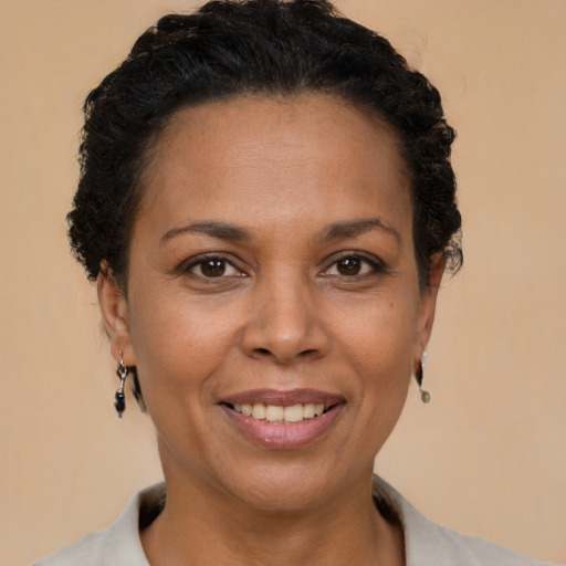 Joyful latino adult female with short  brown hair and brown eyes