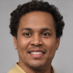 Joyful latino young-adult male with short  brown hair and brown eyes