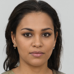 Joyful latino young-adult female with medium  brown hair and brown eyes