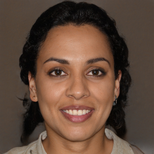 Joyful latino young-adult female with medium  black hair and brown eyes