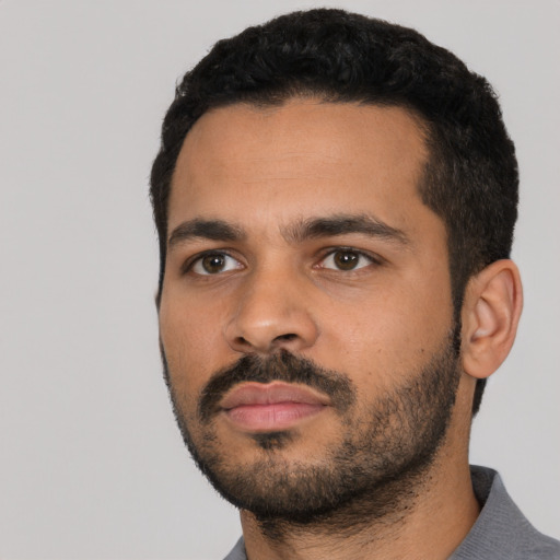 Neutral latino young-adult male with short  black hair and brown eyes