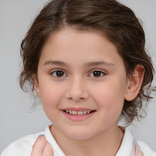 Joyful white child female with medium  brown hair and brown eyes