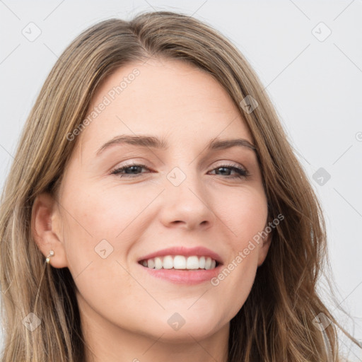 Joyful white young-adult female with long  brown hair and green eyes