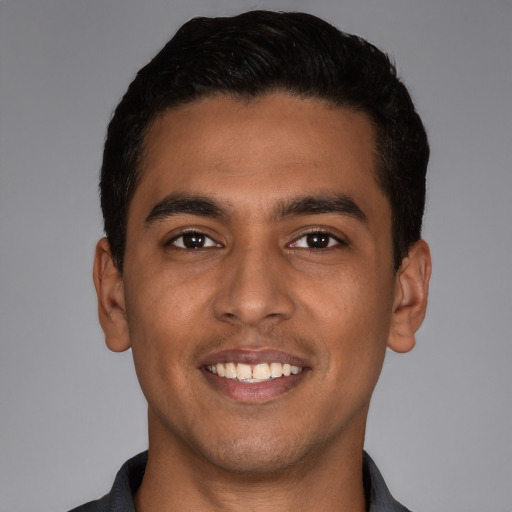 Joyful latino young-adult male with short  black hair and brown eyes