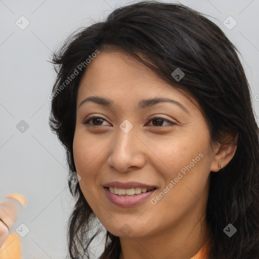 Joyful latino young-adult female with long  brown hair and brown eyes