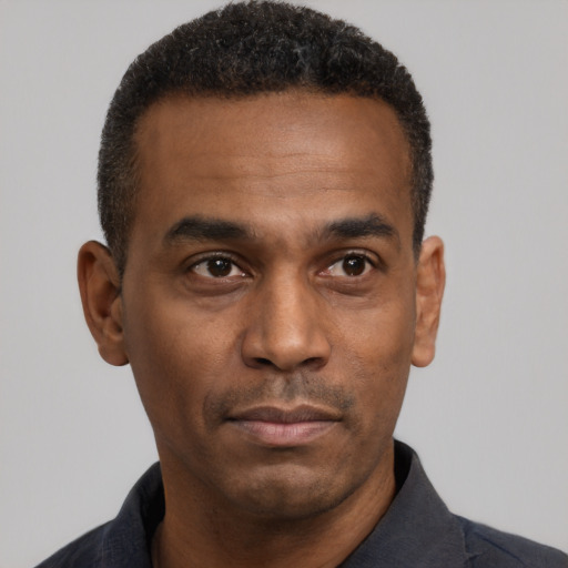 Neutral black adult male with short  black hair and brown eyes